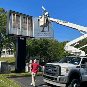 Professional sign installation service in Metro Atlanta GA by Signs & More technician using bucket truck for commercial monument sign